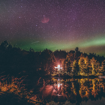 Light shining over a lake at night
