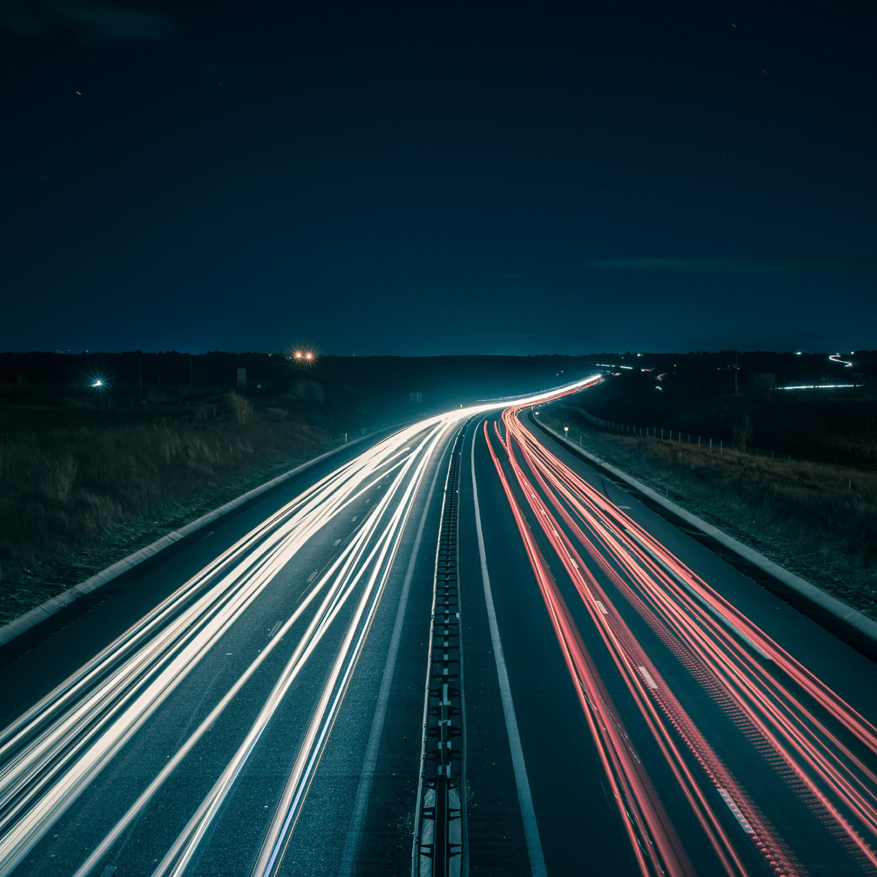 Blurred lights of fast cars along motorway