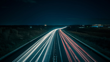 Blurred lights of fast cars along motorway