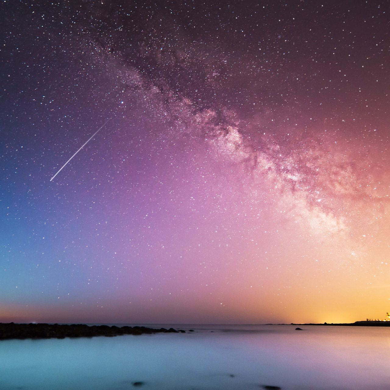 Person looking through telescope at galaxy