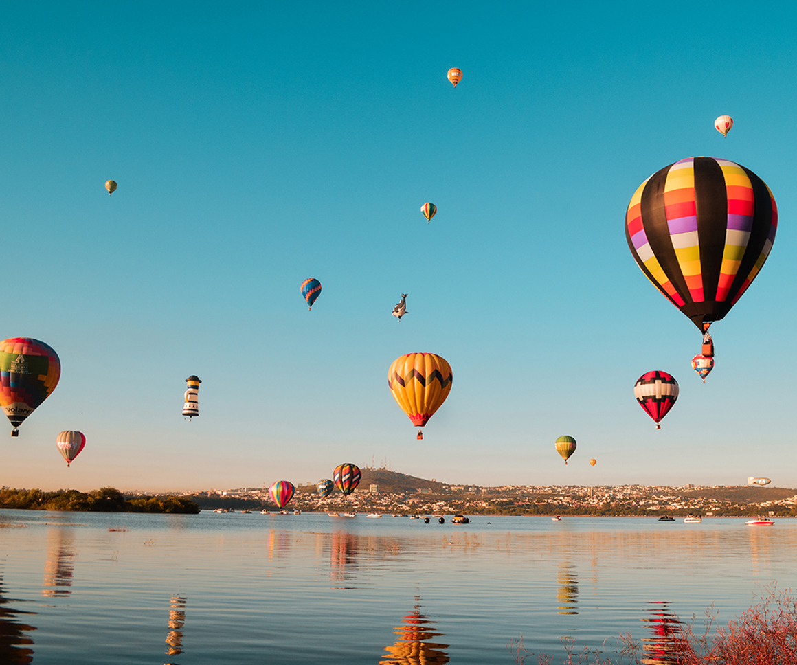 Hot air balloons over water